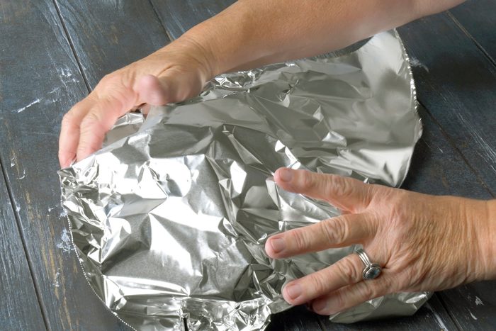 Tent with foil after baking the pork in the pan
