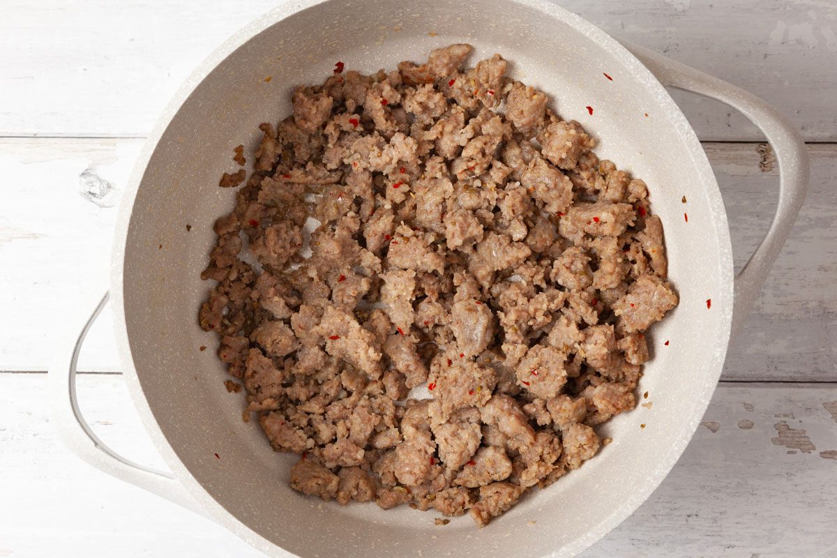 Step 2 of Taste of Home Sausage Mac and Cheese is to melt the butter over medium heat. Add the sausage and cook until it's no longer pink; for about four to five minutes, breaking  it into crumbles. Drain. Remove the sausage with a slotted spoon and set aside.