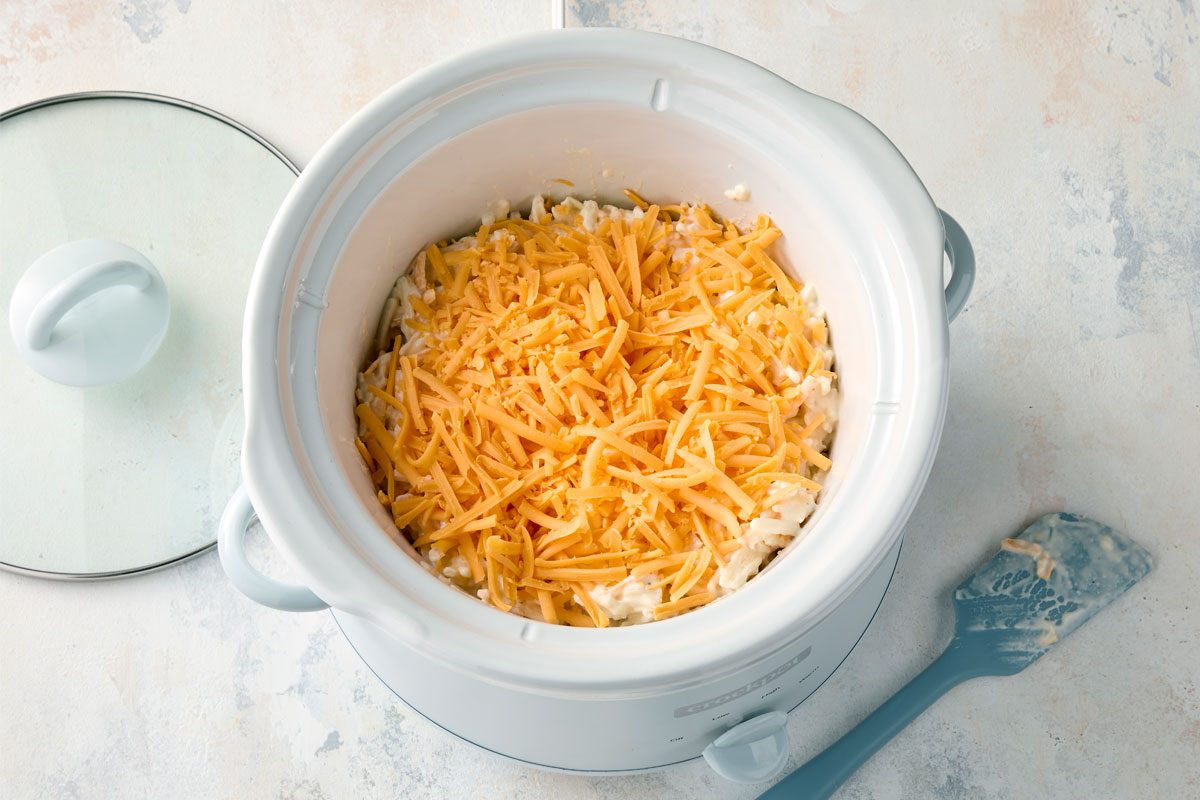 Sprinkle Remaining 1 Cup Shredded Cheese On Top of the casserole inside the slow cooker