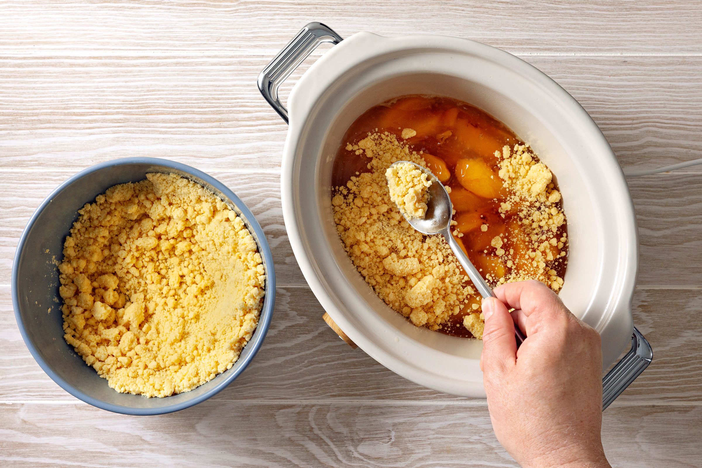 Crumbly mix of cake mix and melted butter with peaches
