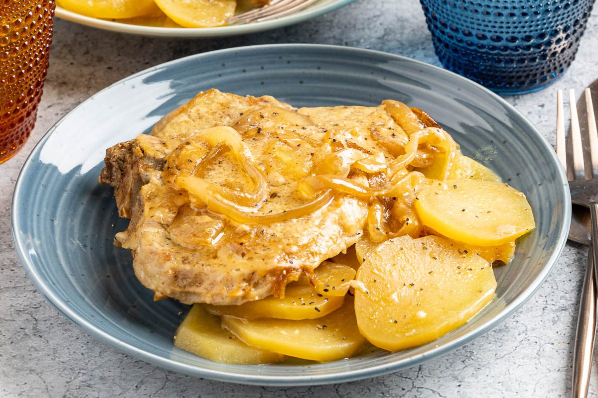 Taste of Home Slow Cooker Pork Chops and Potatoes photo of the finished recipe served on plates.