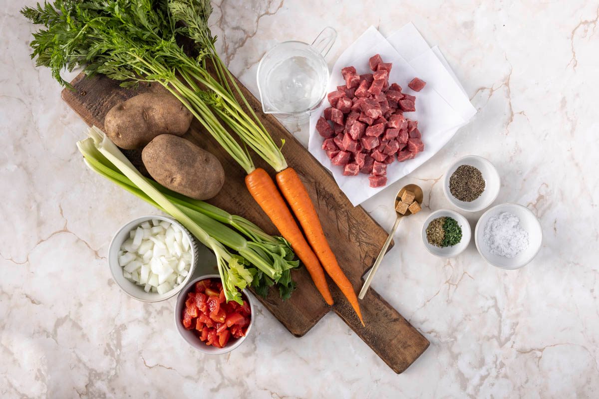 Slow Cooker Vegetable Soup Ingredients overhead on marble table