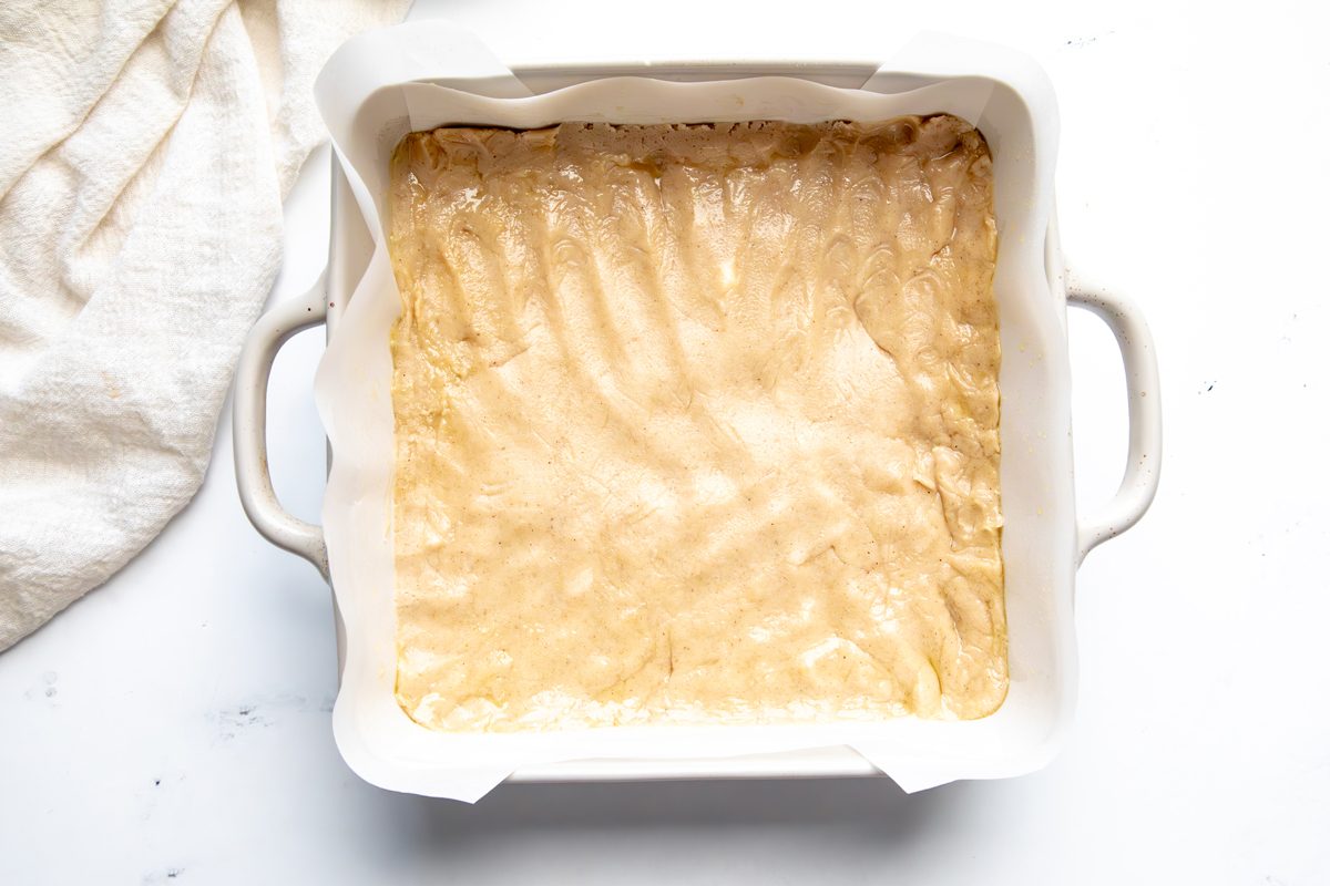 Overhead shot for Taste of Home Snickerdoodle Cheesecake Bars, cookie crust before being baked in a baking dish.