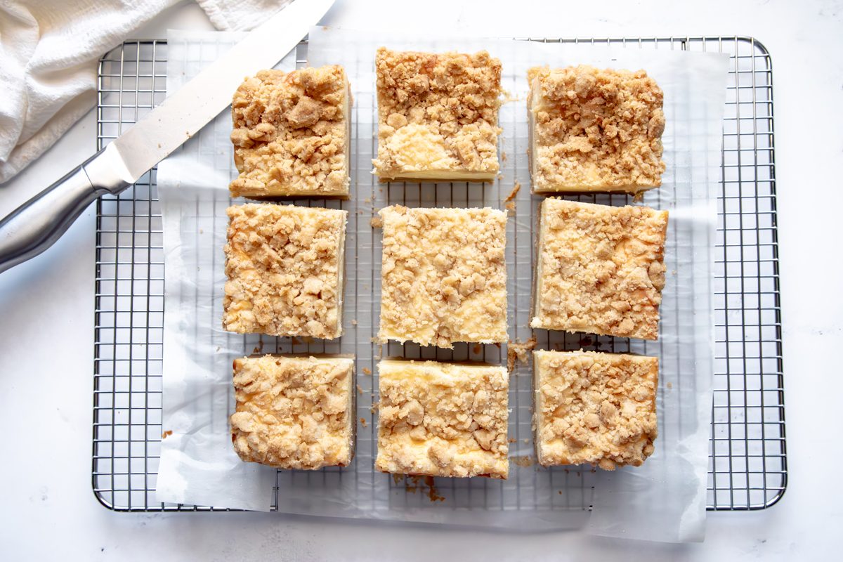 Overhead shot for Taste of Home Snickerdoodle Cheesecake Bars, cooling on a wire rack.