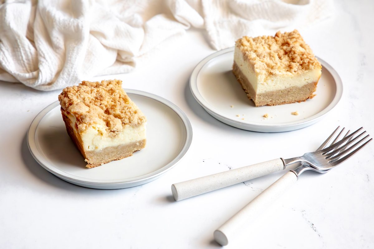 Beauty shot for Taste of Home Snickerdoodle Cheesecake Bars being served on plates.