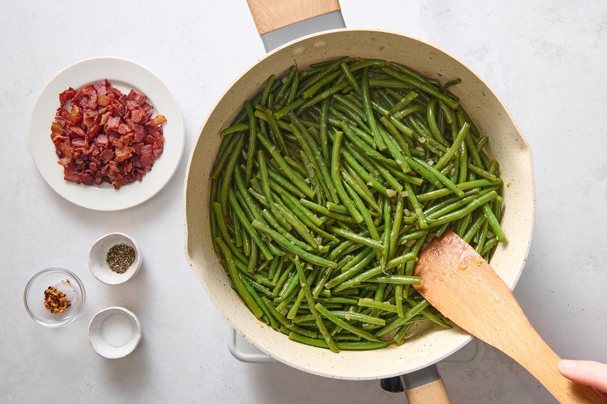 Sautéing the green beans in the skillet before adding the remaining ingredients