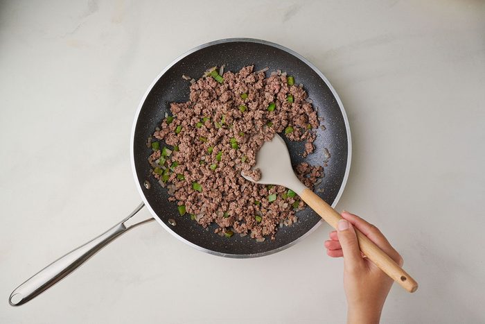 Cooking ground beef with green pepper and onion for Taste of Home's Spanish Noodles recipe