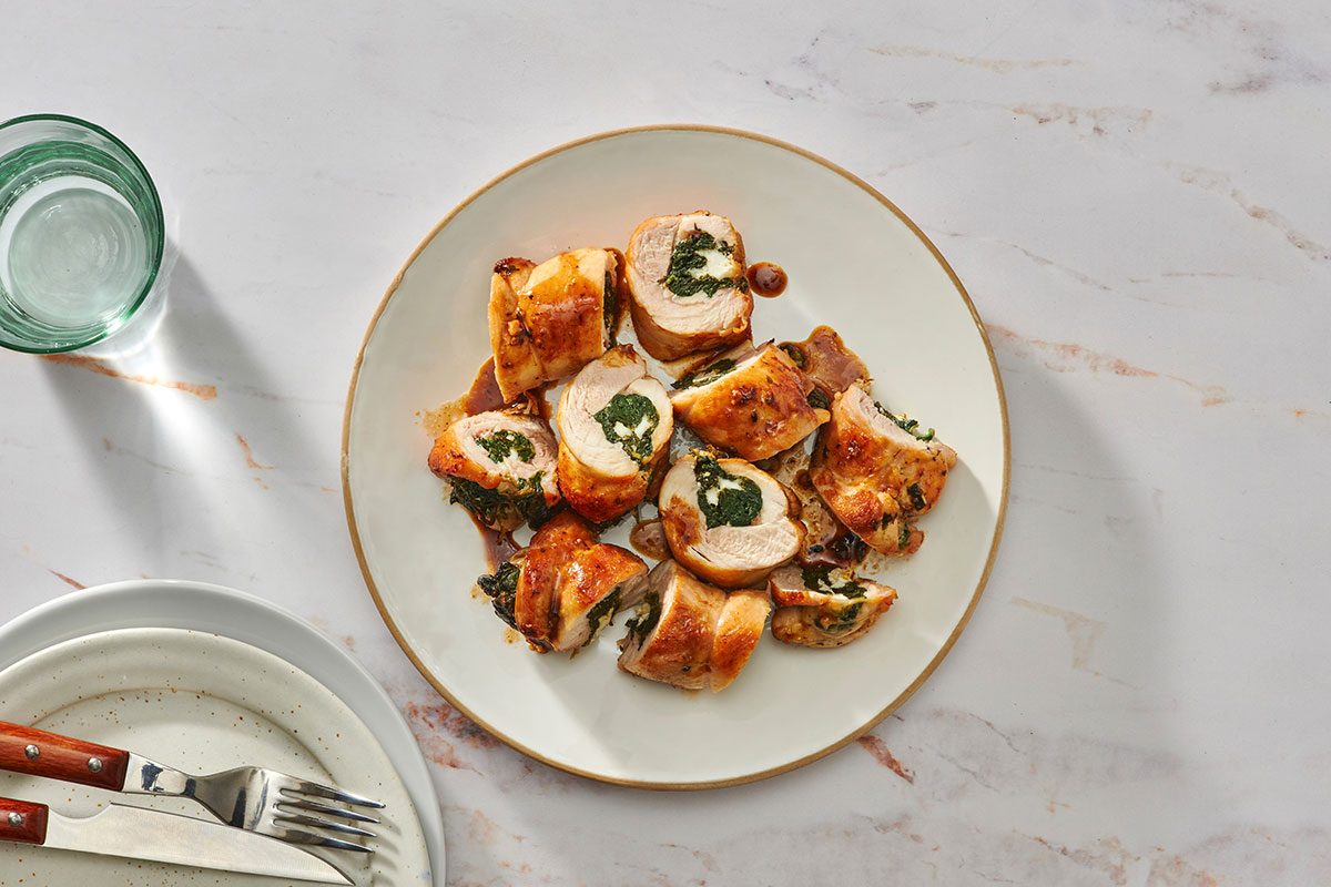 Spinach and feta stuffed chicken on a serving platter