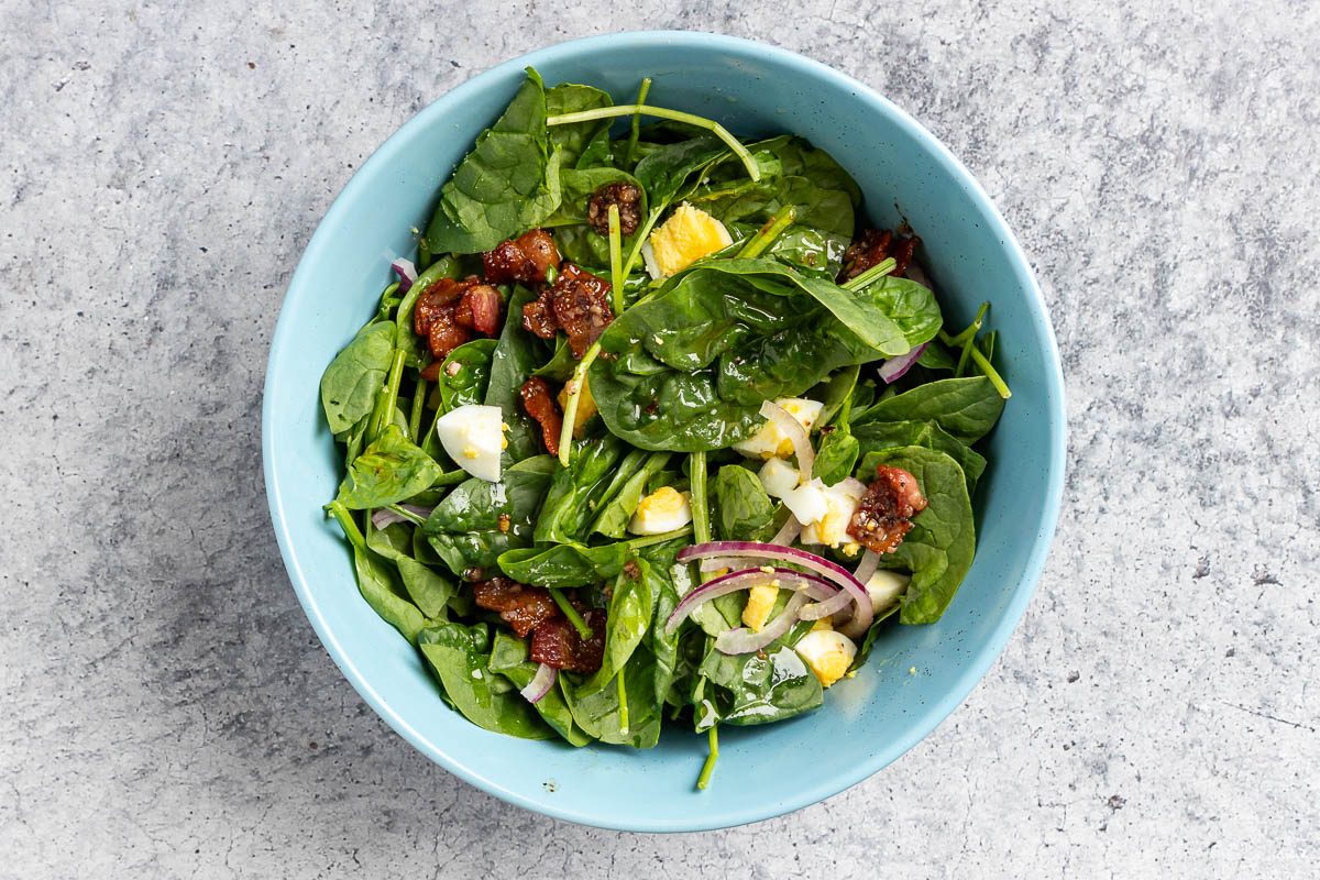 assembled spinach salad in a bowl
