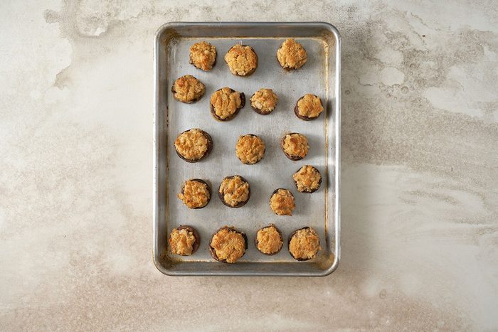 Baking the mushrooms stuffed with crabmeat at 400°F until tender, for the Stuffed Mushrooms with Crabmeat recipe, by Taste of Home.
