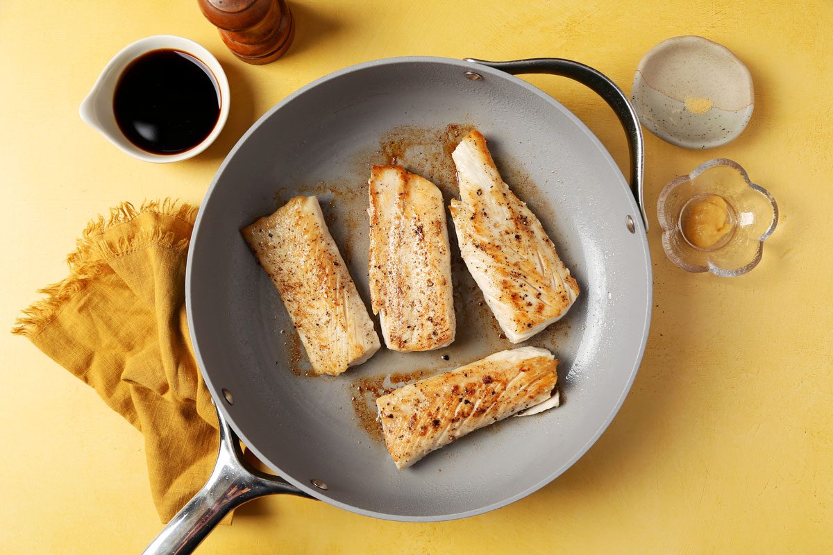Process of making Taste of Home's Teriyaki Mahi Mahi laid out in small bowls on bright yellow surface.
