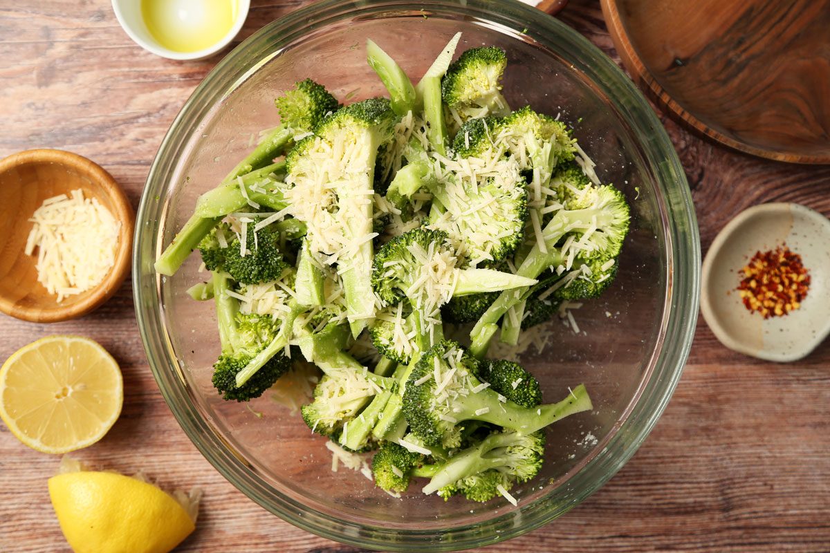 Process of making Taste of Home's Grilled Broccoli grilled and on a plate on a brown wooden surface.