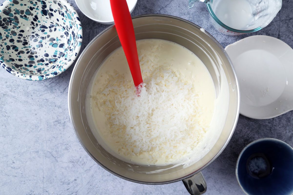 Process of making Taste of Home's Coconut Cheesecake on a dark blue surface.