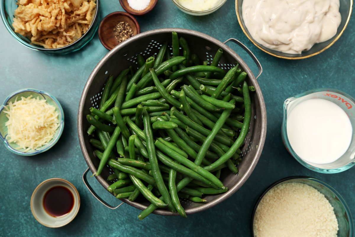 Process of making Taste of Home's Gluten Free Green Bean Casserole in a white casserole dish on a teal surface.