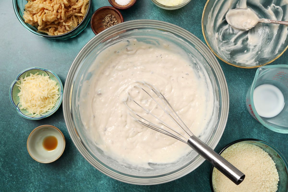 Process of making Taste of Home's Gluten Free Green Bean Casserole in a white casserole dish on a teal surface.