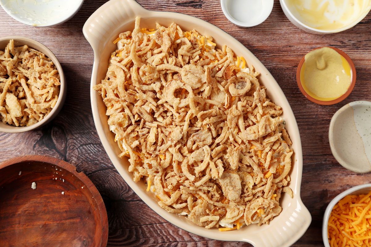 Process of making Taste of Home's French Onion Chicken Casserole on a brown wooden surface.
