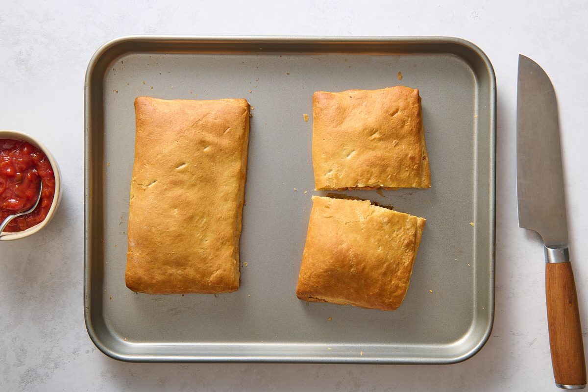 Taco pockets after being baked, with one cut in half