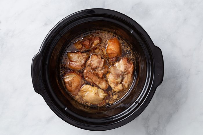Slow cooked chicken thighs in Teriyaki sauce for step two of Teriyaki Chicken Thigh recipe for Taste of Home
