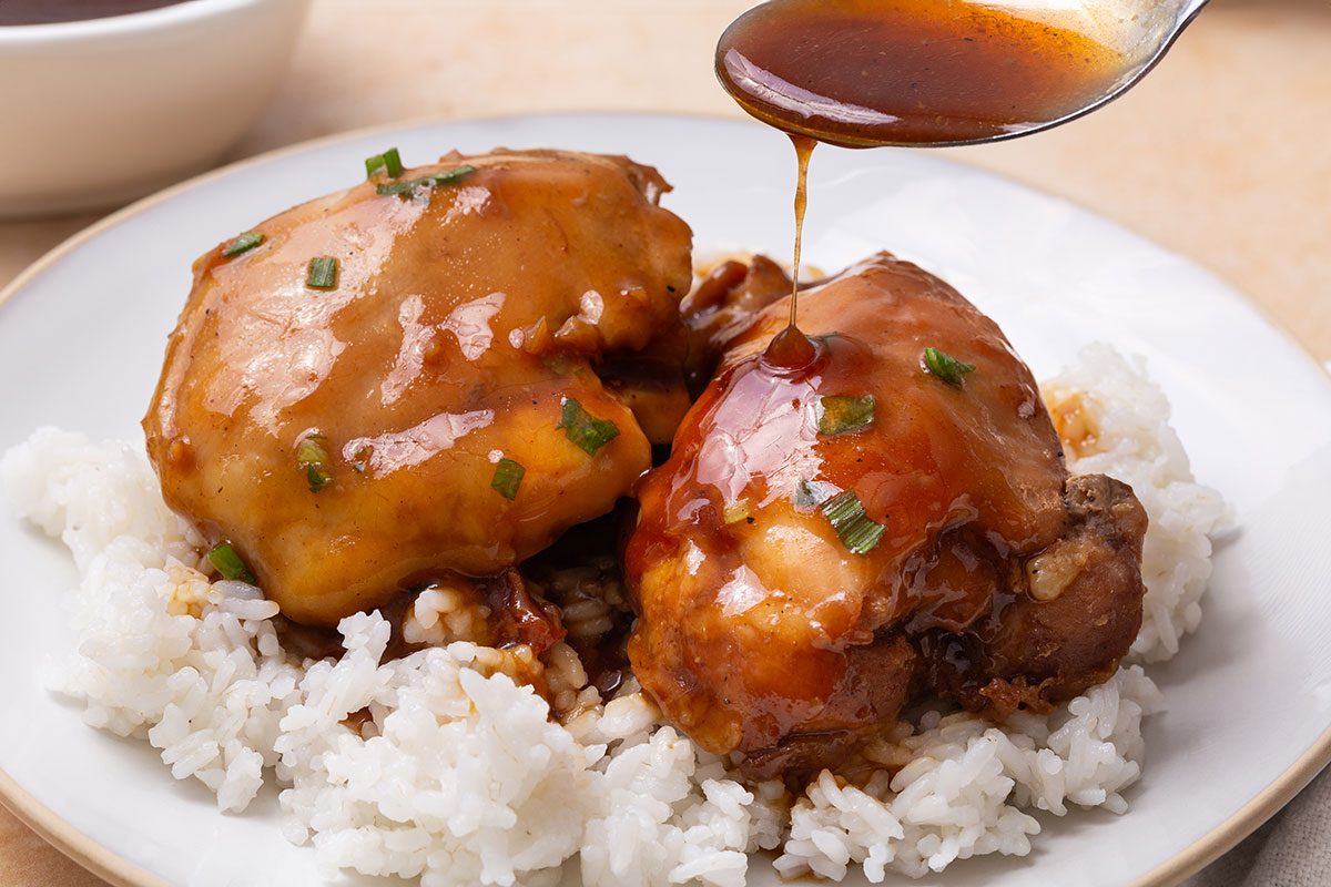 Teriyaki Chicken Thighs on a serving platter garnished with green onion for Taste of Home