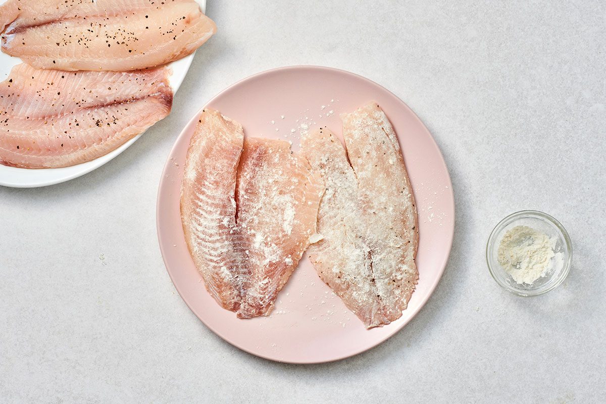 Seasoned tilapia fillets on a plate