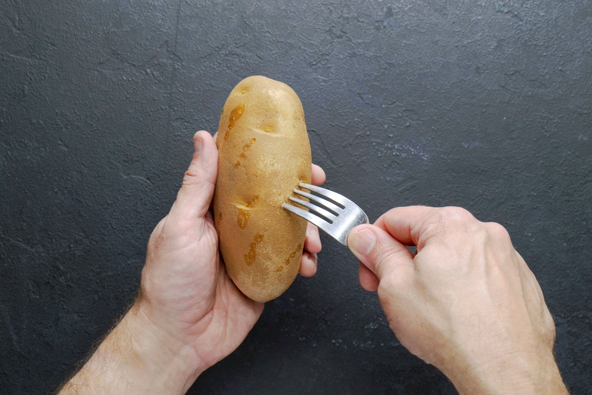 Piercing a potato using a fork