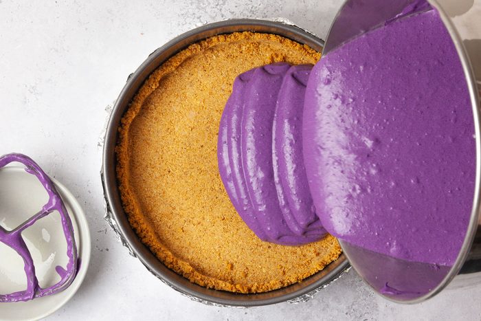 Step 3 of Taste of Home Ube Cheesecake is to pour the filling into the crust