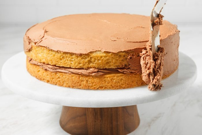 Top and sides of a two-layer cake being frosted.