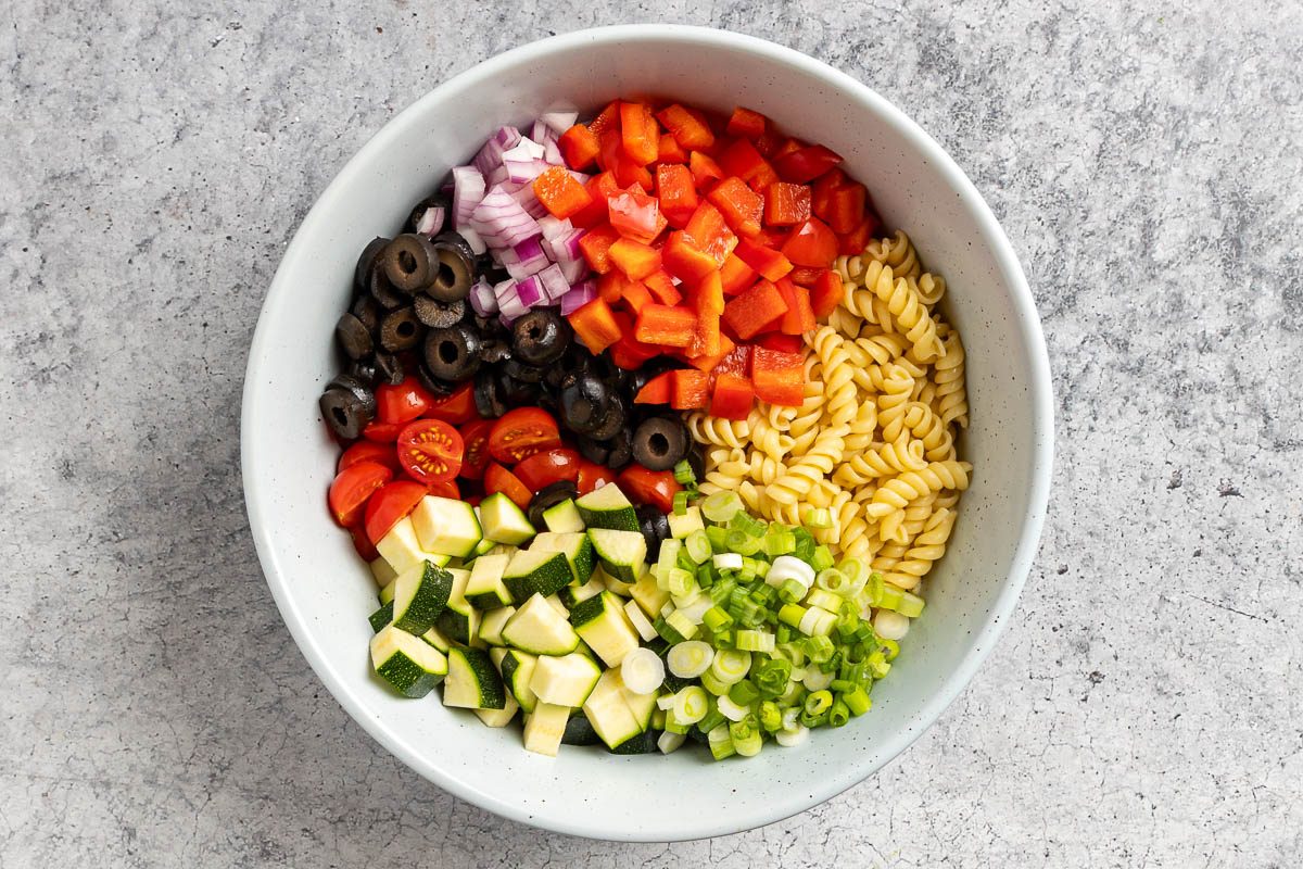 Taste of Home Vegan Pasta Salad photo of all the veggies and pasta in a mixing bowl.