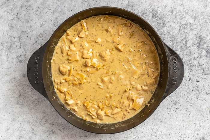 Taste of Home White Lasagna Soup photo of adding the cream and noodles.