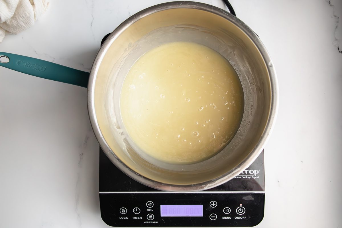 Overhead shot for Taste of Home White Chocolate Ganache, with the white chocolate and heavy cream being melted in a double boiler.