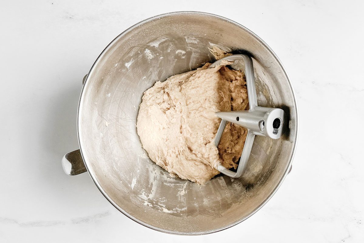 Dough for Taste of Home Whole Wheat Rolls in a mixer bowl