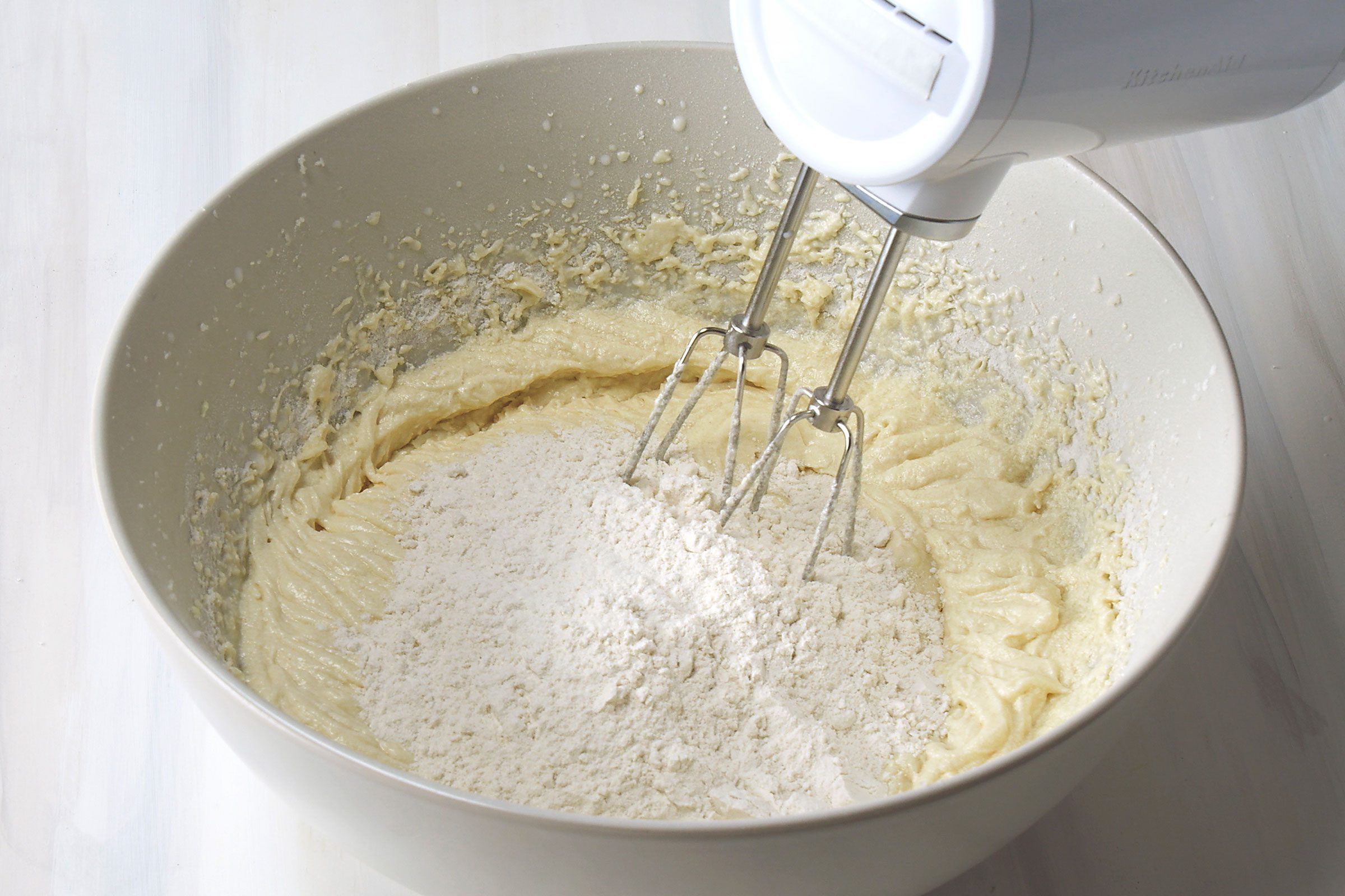Adding dry ingredients to butter and sugar mixture