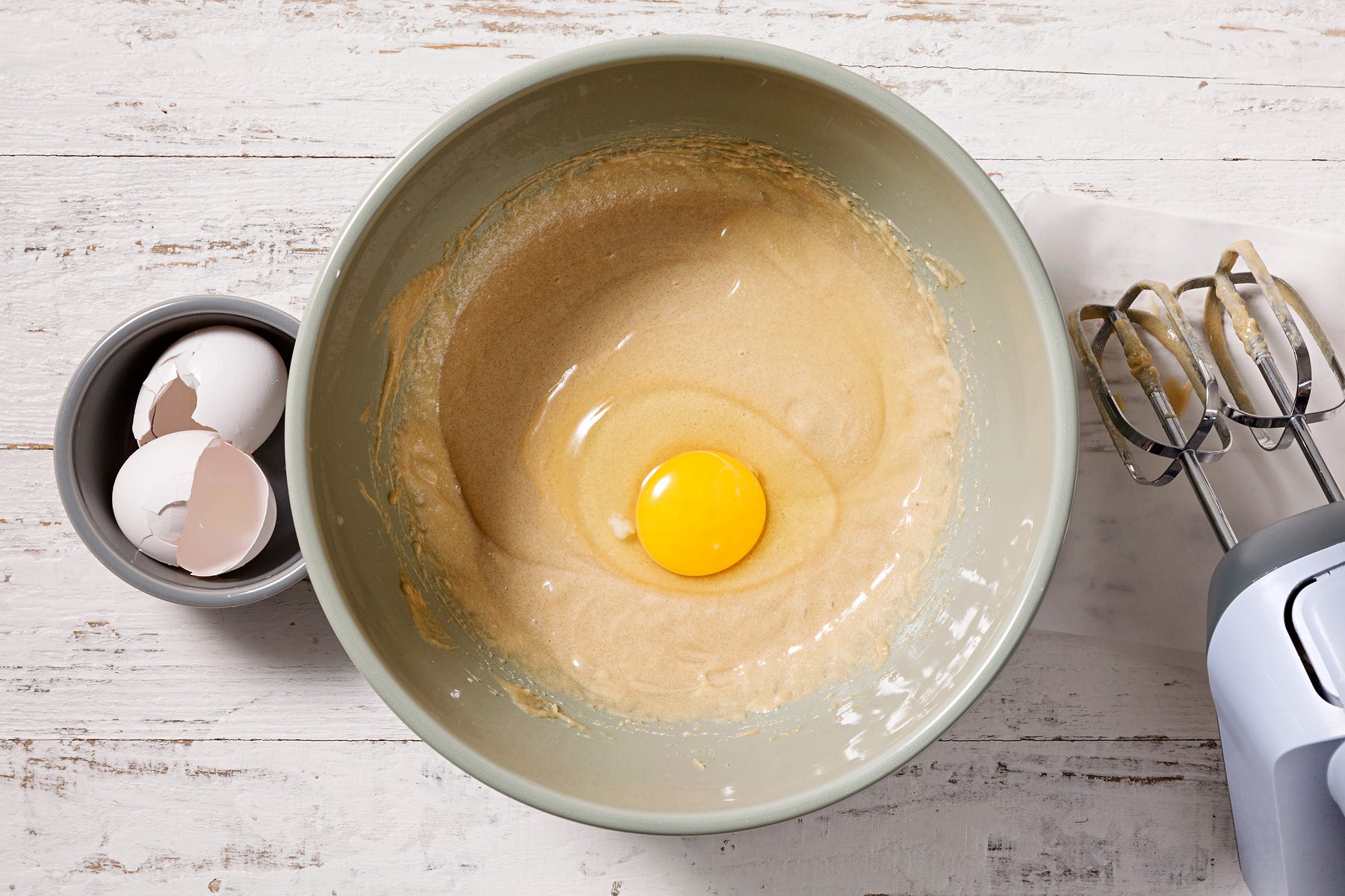 Add eggs, one at a time.