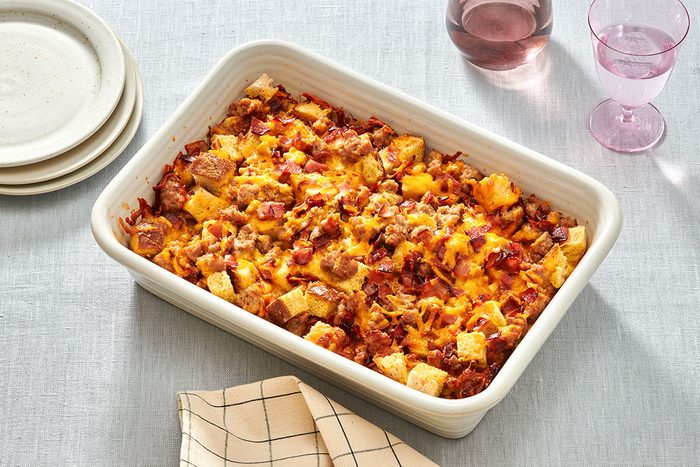 Sausage strata in a baking dish with one portion removed