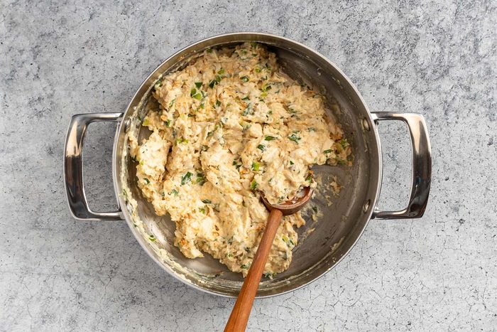 Taste of Home Chicken Croquettes photo of adding the chicken, vegetables, and seasonings.