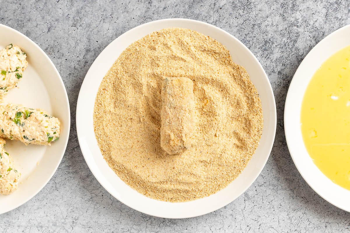 Taste of Home Chicken Croquettes photo of coating the croquettes.