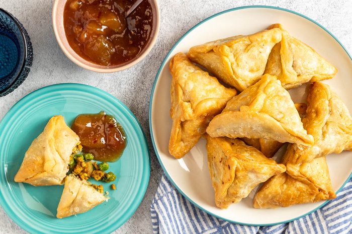 Taste of Home Chicken Samosa photo of the finished recipe served on plates.