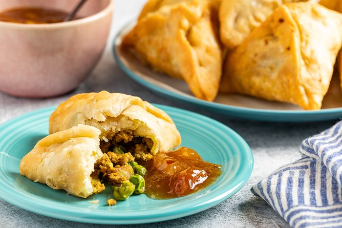 Taste of Home Chicken Samosa photo of the finished recipe served on plates.