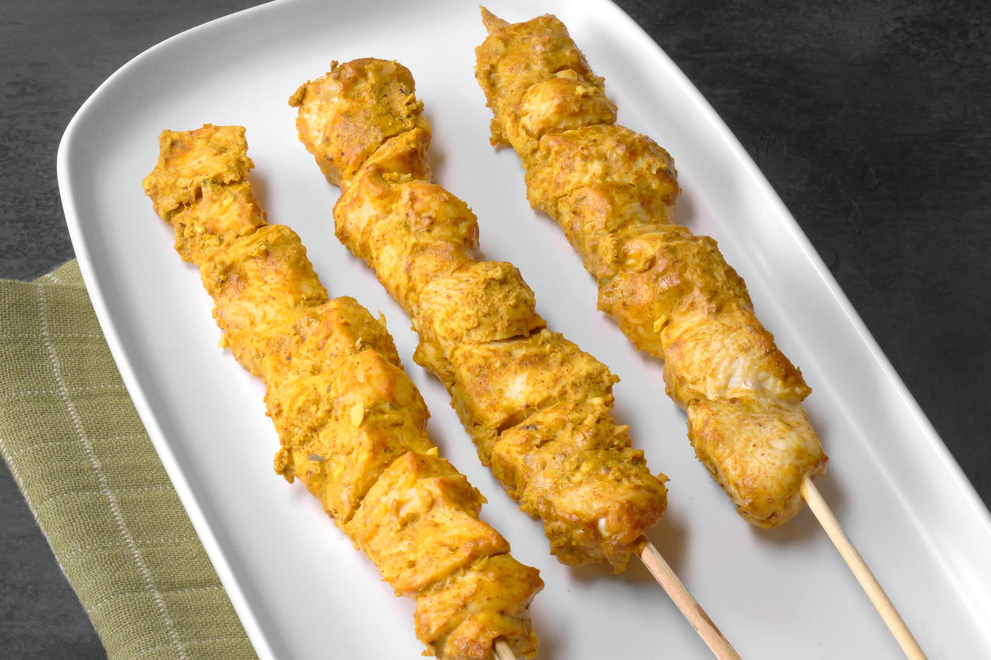 Chicken Tikka skewers arranged in a serving plate