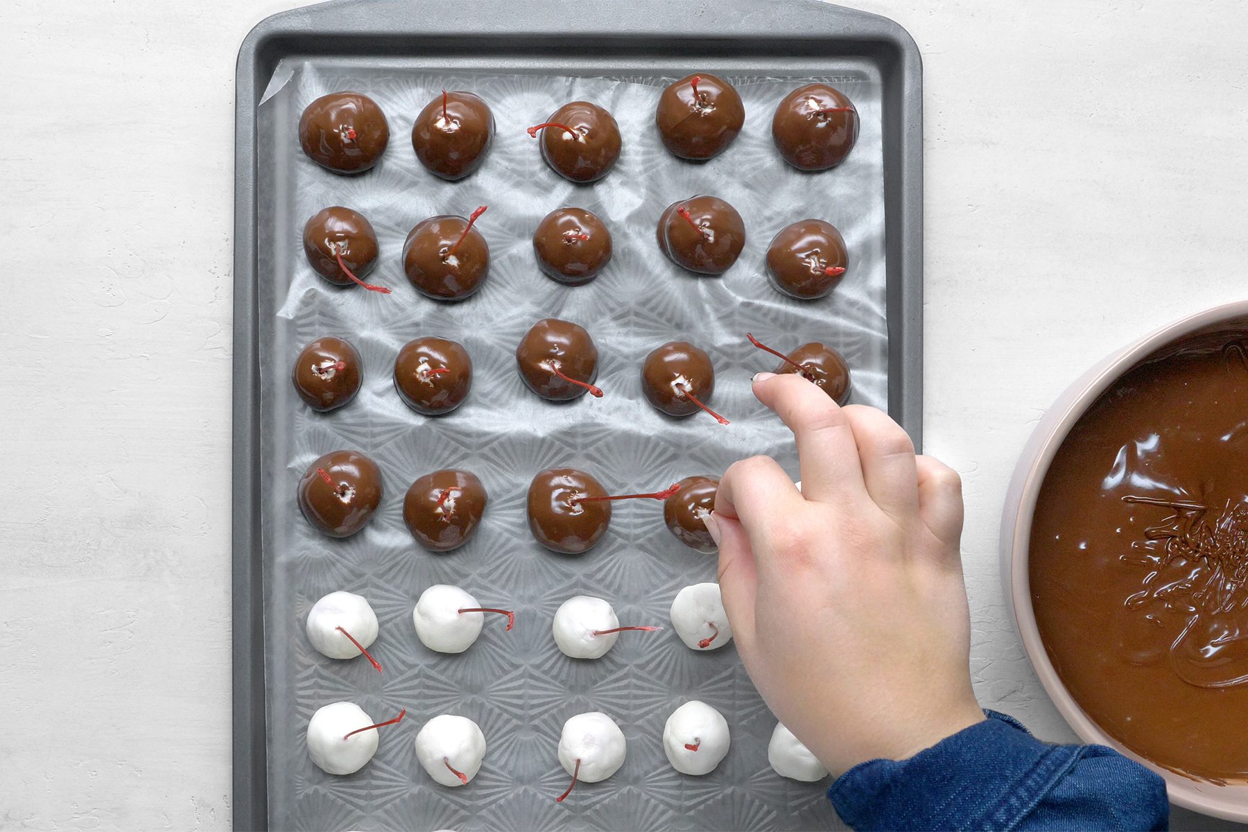 dip cherries into chocolate; allow excess to drip off.
