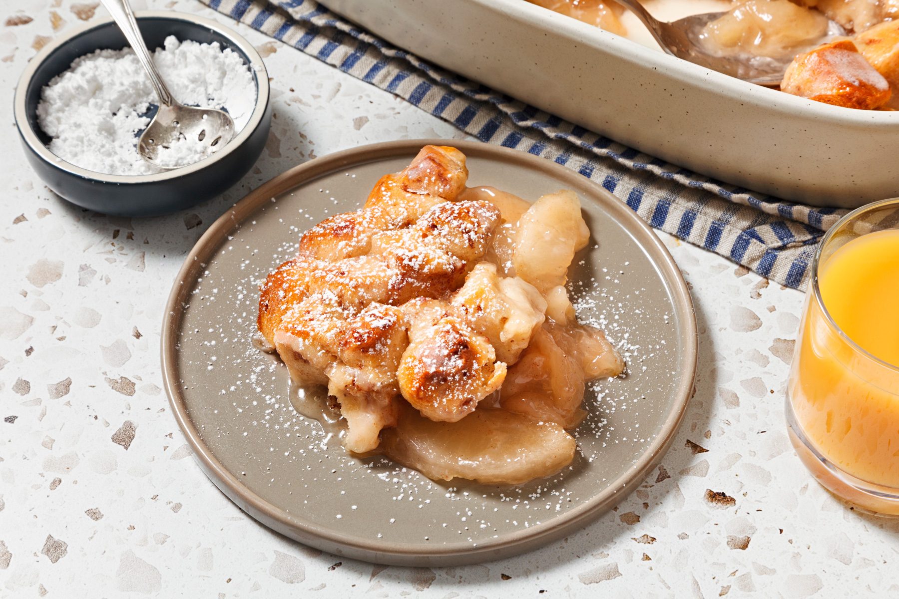 3/4th angle shot of cinnamon rolls with apple pie filling.