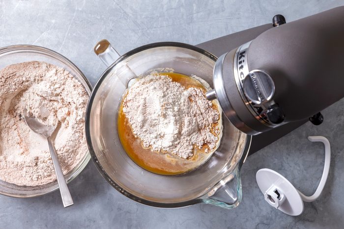 Overhead shot; To the mixing bowl add honey; molasses and espresso powder; stir to combine; add sifted ingredients; blend on low speed 2-3 minutes; Increase speed to medium-low; knead until dough is smooth and elastic and begins to pull away from the sides of the bowl 6-8 minutes; grey surface;