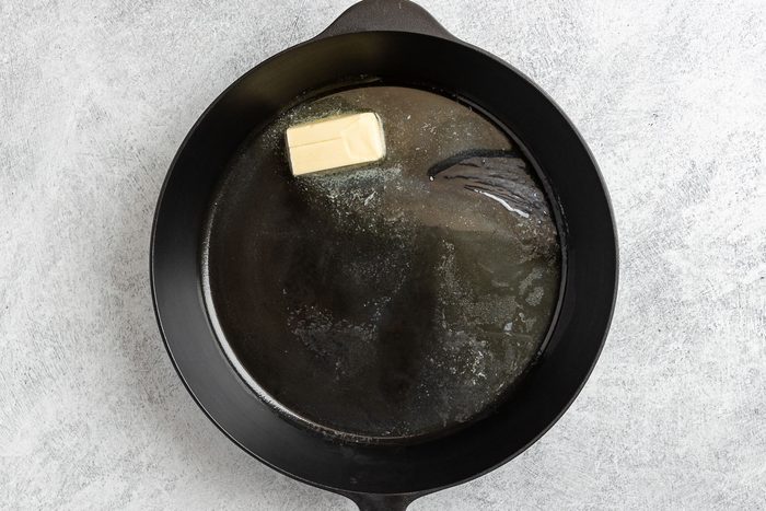 Taste of Home Grilled Catfish photo of melting the butter in a cast iron skillet.