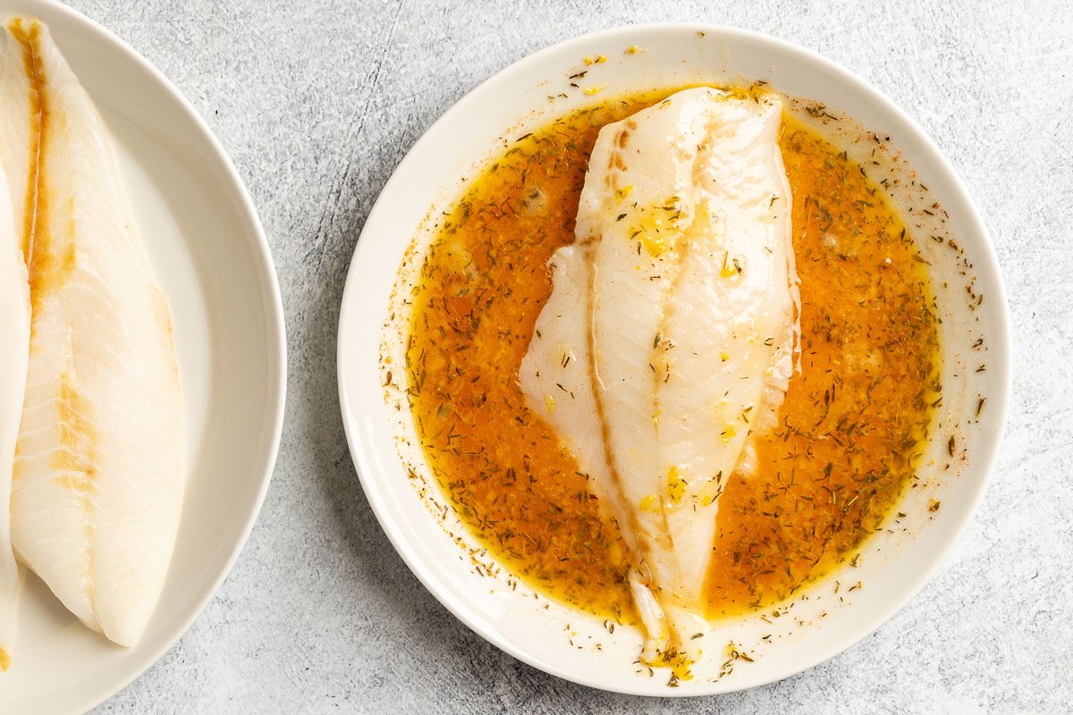 Taste of Home Grilled Orange Roughy photo of dipping the fish in the lemon mixture.