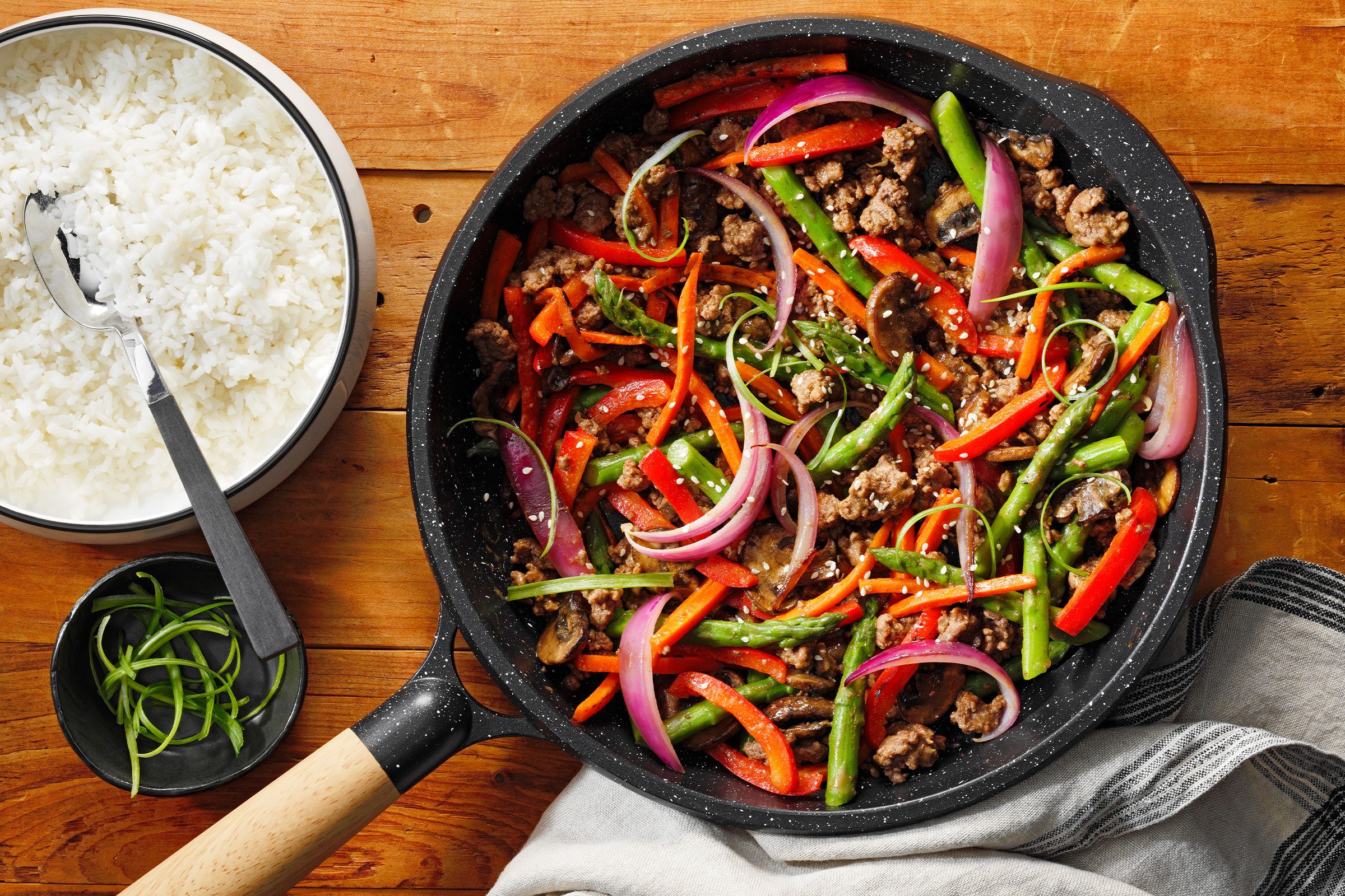 Ground Beef Stir Fry in a pan with rice on side