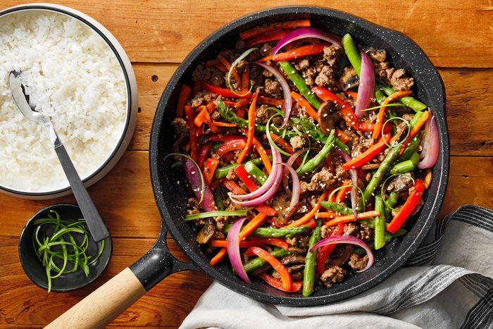 Ground Beef Stir Fry in a pan with rice on side