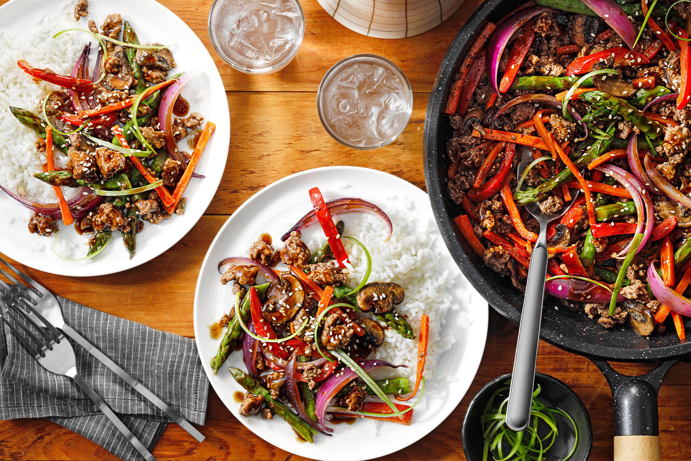 Ground Beef Stir Fry in a pan and served in two white plates with fork on side