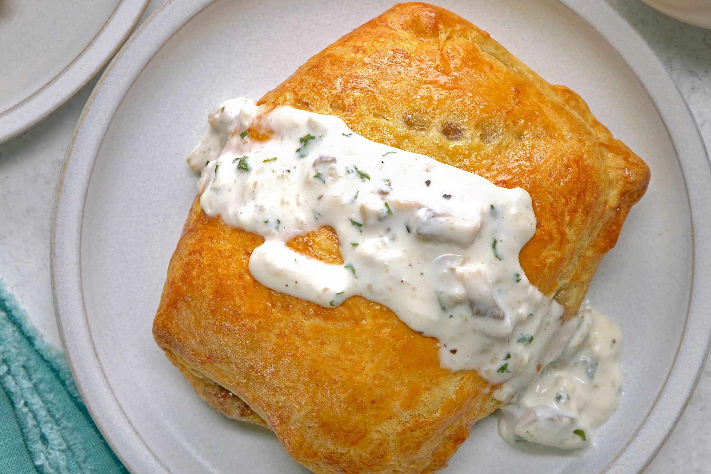 Ground Beef Wellington served on a white plate