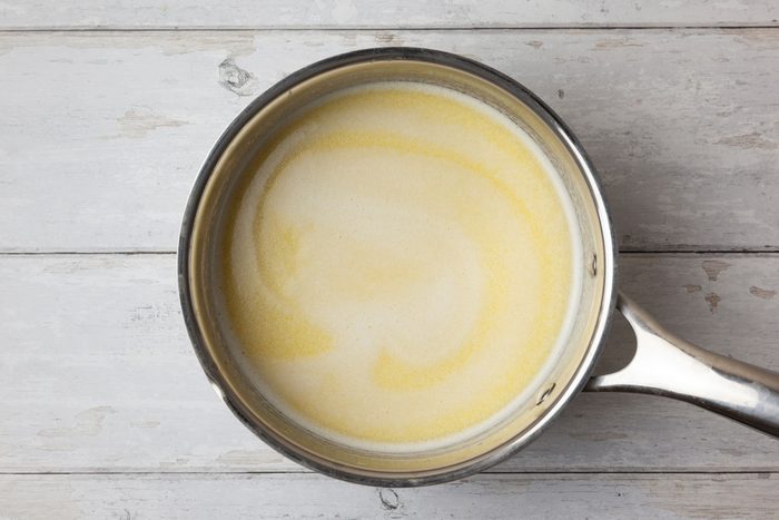 Step 2 of Taste of Home Hawaiian Sweet Bread is to heat the butter, milk and juice