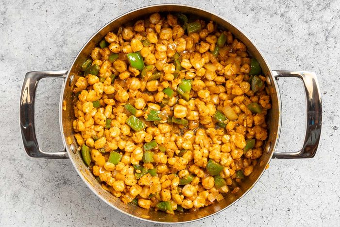 Taste of Home Hominy Recipe photo of the hominy and seasonings added to the pan.